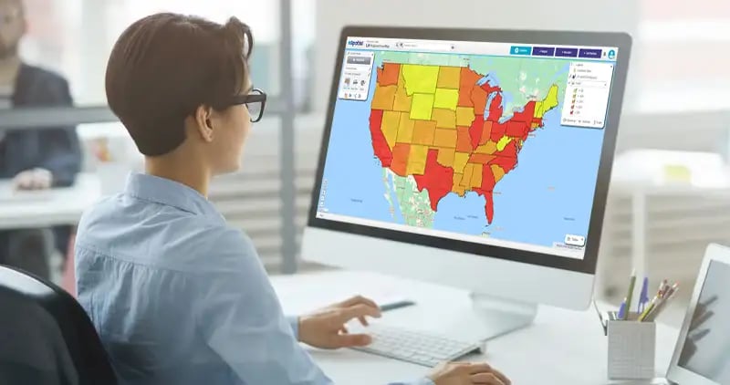 Person looking at monitor with US state regional heat map